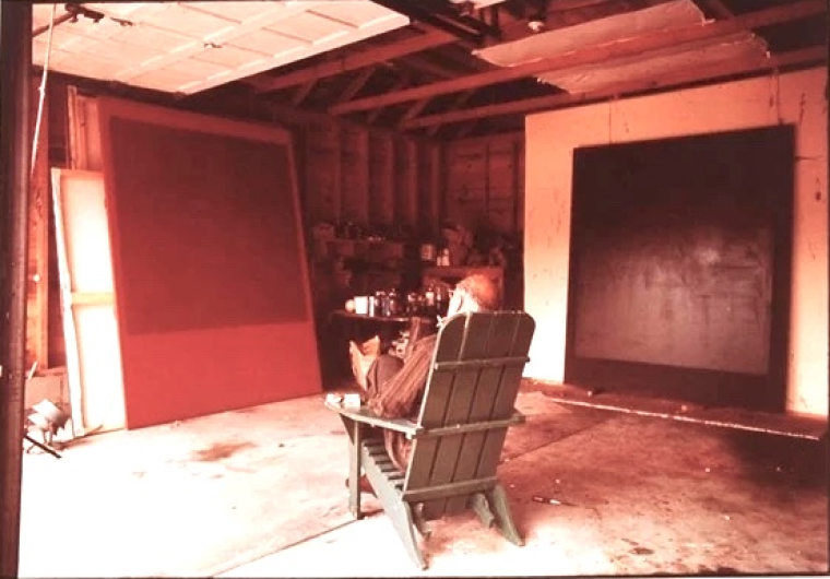 Mark Rothko in his studio studying an image